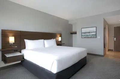 a large white bed in a hotel room at Great Blue Heron Hotel in Port Perry
