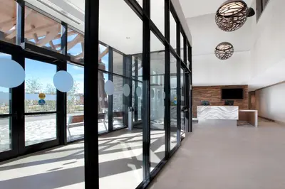a room with large glass doors and a view of a building at Great Blue Heron Hotel in Port Perry