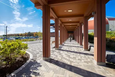 a walkway leading to a building with columns at Great Blue Heron Hotel in Port Perry