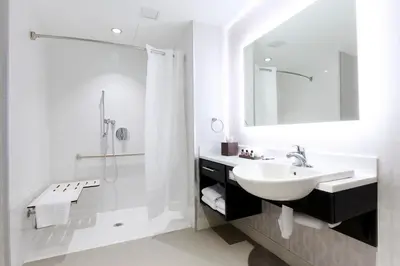 a white bathroom with a sink and a shower at Pickering Casino Resort in Pickering