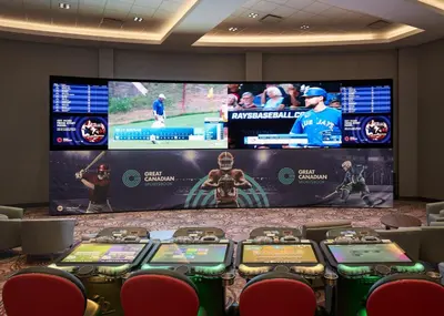 a room with a large screen with a video game at Pickering Casino Resort in Pickering