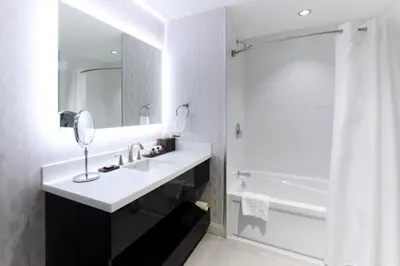 a white bathroom with a sink and a shower at Pickering Casino Resort in Pickering