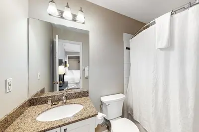 a bathroom with a sink and a toilet and a mirror at Condo 916 at North Creek Resort in Blue Mountains
