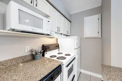 a kitchen with a stove and a microwave at Condo 916 at North Creek Resort in Blue Mountains