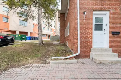 a white hose is on the side of a brick building at Harmony Home Near University of Waterloo in Waterloo