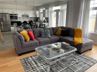 a living room with a couch and a table at Rest in Quinte West - 25 mins from Batawa Ski Hill in Carrying Place