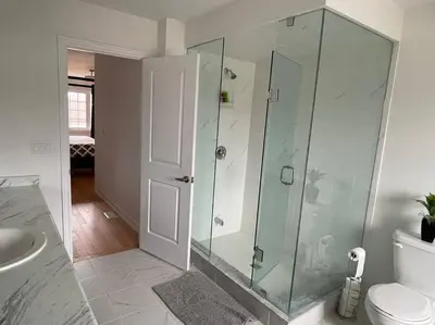 a bathroom with a glass shower and a toilet at Rest in Quinte West - 25 mins from Batawa Ski Hill in Carrying Place