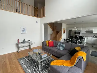 a living room with a couch and a table at Rest in Quinte West - 25 mins from Batawa Ski Hill in Carrying Place