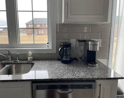 a kitchen counter with a coffee maker on a counter top at Rest in Quinte West - 25 mins from Batawa Ski Hill in Carrying Place