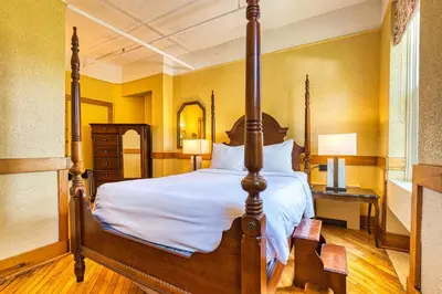 a bedroom with a bed and a dresser and two lamps at The Stratford Hotel by Hoco Hotels Collection in Stratford