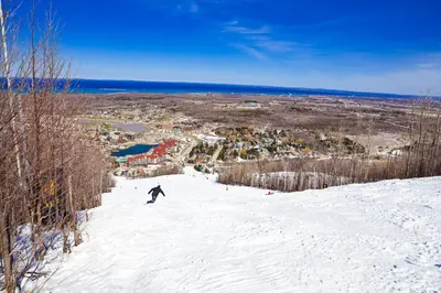 a person riding a snowboard down a snow covered slope at Condo 912 at North Creek Resort in Blue Mountains