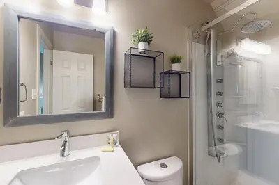 a bathroom with a sink and a toilet and a mirror at Condo 912 at North Creek Resort in Blue Mountains