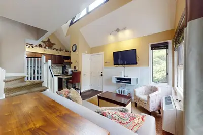 a living room with a couch and a tv at Condo 912 at North Creek Resort in Blue Mountains