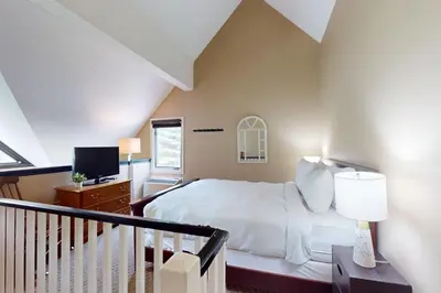a bedroom with a bed and a tv in it at Condo 912 at North Creek Resort in Blue Mountains