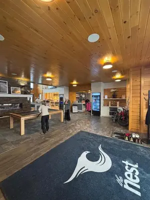a person playing ping pong in a room with a table at Stunning Stayz Luxury 2 King Suite at Friday Harbour Resort Marina Walk & Parking in Innisfil