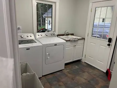 a kitchen with a stove and a sink and a door at WELCOME TO BURNT RIVER ESTATE in Kawartha Lakes