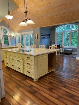an open kitchen and dining room with a large island at WELCOME TO BURNT RIVER ESTATE in Kawartha Lakes