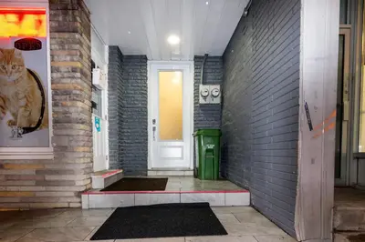 a hallway with a cat sitting next to a door at Downtown Retreat-Spacious Rooms with Shared Kitchen & Bath in Toronto