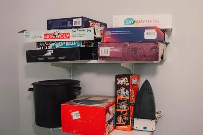 a pile of books on a shelf in a room at Sun Chaser Bay in Carrying Place