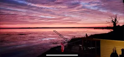a view of a sunset over a body of water at Sun Chaser Bay in Carrying Place