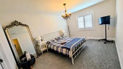 a bedroom with a bed and a mirror at Exclusive Townhome near West-Side Trails in Waterloo