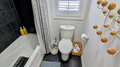 a bathroom with a toilet and a bath tub at Exclusive Townhome near West-Side Trails in Waterloo