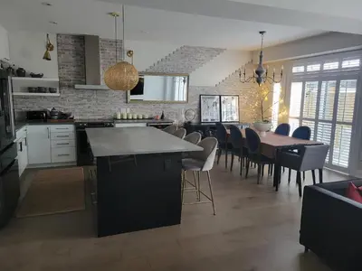 a kitchen and dining room with a table and chairs at Exclusive Townhome near West-Side Trails in Waterloo