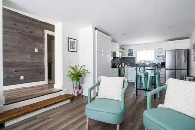 a living room with two chairs and a kitchen at 