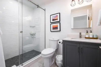 a bathroom with a shower and a toilet and a sink at 