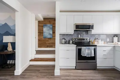 a kitchen with white cabinets and a stove at 