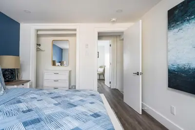 a bedroom with a bed and a large painting on the wall at 