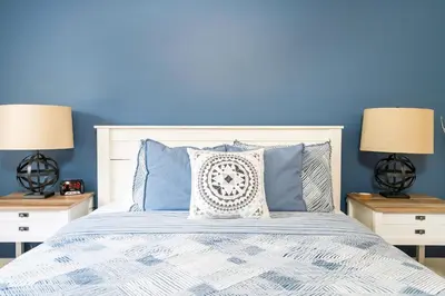 a blue bedroom with a bed with blue walls at 
