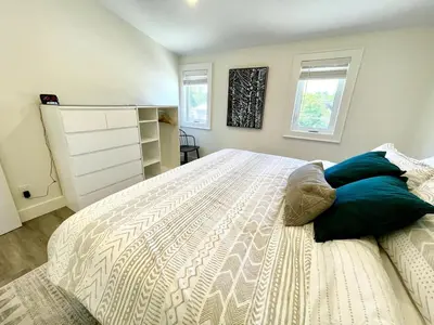 a bedroom with a large bed with blue pillows at 