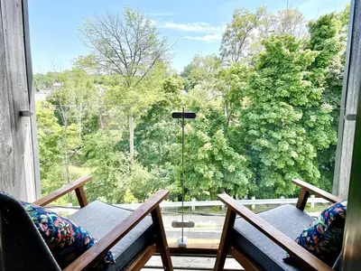a balcony with two chairs and a large window at 