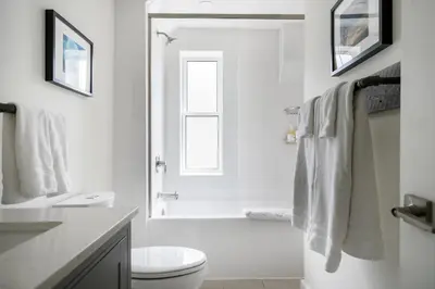 a white bathroom with a shower and a toilet at 