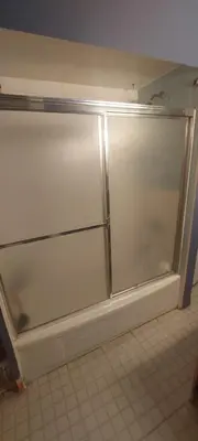 a sliding glass door in a kitchen with a tile floor at Zen Hostel in Toronto