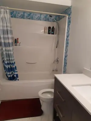 a bathroom with a toilet and a shower and a sink at ComfyRoom in Toronto