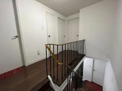 an empty room with a spiral staircase in a house at ComfyRoom in Toronto
