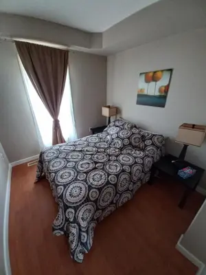 a bedroom with a large bed and a window at Niagara Falls Dream Family Retreat in Niagara Falls