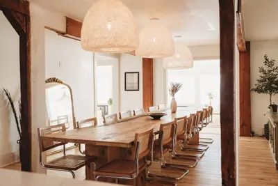 a long wooden table and chairs in a room at Beach House in Niagara in Wainfleet