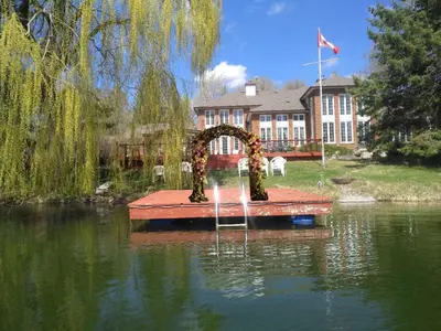 a fountain in the middle of a pond in front of a house at Lakeside Private suite-Queen bed room in Tottenham