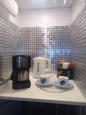 a coffee maker and two cups on a counter at Lakeside Private suite-Queen bed room in Tottenham