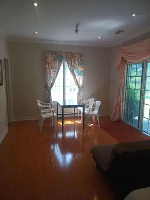 a living room with a dining room table and chairs at Resort style entire guesthouse-2 rooms in Tottenham