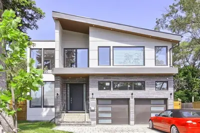 a house with a red car parked in front of it at Charming and Luxurious 2BR+1Bath Guest Suite in Toronto