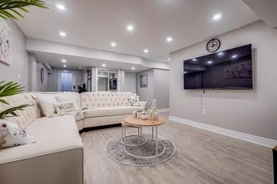 a living room with a white couch and a table at Vacation Suite in Pickering in Pickering