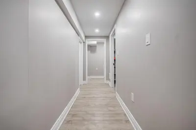 an empty hallway with white walls and wooden floors at Vacation Suite in Pickering in Pickering