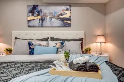 a bedroom with a bed with a tray of towels at Vacation Suite in Pickering in Pickering