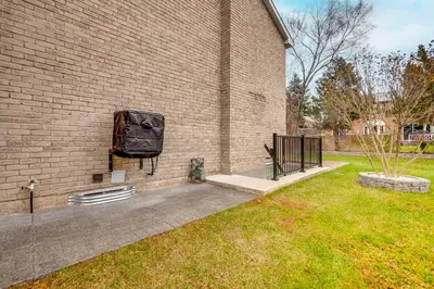 a television hanging on the side of a brick building at Vacation Suite in Pickering in Pickering