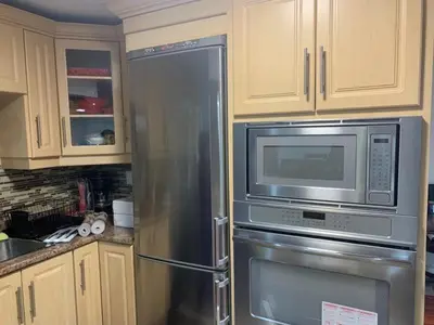 a kitchen with a stainless steel refrigerator and microwave at Guest House Room No 01 in Mississauga