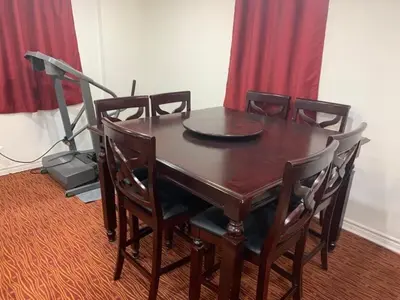 a wooden table with chairs and a lamp in a room at Guest House Room No 01 in Mississauga